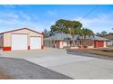 Property featuring a house and a large detached garage at 13101 Delbarton St, Spring Hill, FL 34609