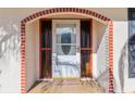 White front door with arched brick entryway and sidelights at 13101 Delbarton St, Spring Hill, FL 34609