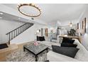 Open living area with sectional sofa, ottoman, and view of upper level at 162 E Davis Blvd, Tampa, FL 33606