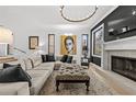 Light and airy living room featuring a fireplace, sectional sofa, and large artwork at 162 E Davis Blvd, Tampa, FL 33606