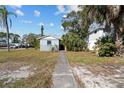 Single story home with walkway and landscaping at 1701 Mississippi Ne Ave, St Petersburg, FL 33703