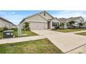Two-story house with a two-car garage, driveway, and front yard at 17019 Avon Dive Ln, Wimauma, FL 33598