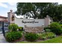 Imperial Cove entrance with lush landscaping and beautiful stonework at 19029 Us Highway 19 N # 26-304, Clearwater, FL 33764