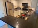 Modern kitchen with stainless steel appliances and granite countertops at 2010 E Palm Ave # 15305, Tampa, FL 33605
