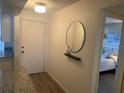Bright condo entry with mirror, floating shelf and view of bedroom at 2465 Northside Dr # 1203, Clearwater, FL 33761