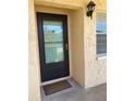 Inviting condo entry with a black door and welcome mat at 2465 Northside Dr # 1203, Clearwater, FL 33761