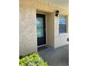 Condo entrance featuring a teal glass door and light colored stucco at 2465 Northside Dr # 1203, Clearwater, FL 33761