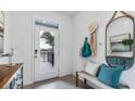 Bright and airy entryway with bench seating and stylish decor at 32603 Turtle Grace Loop, Wesley Chapel, FL 33545