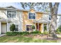 Two-story townhome with landscaping and a tree at 3529 High Hampton Cir, Tampa, FL 33610