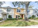 Two-story townhome with a tree and walkway at 3529 High Hampton Cir, Tampa, FL 33610