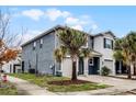 Gray two-story townhome with a side view showcasing landscaping at 3830 Vignoble Ln, Brandon, FL 33511