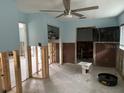 Bedroom awaiting renovation, featuring bare walls, TV, and a glimpse into an attached closet and bathroom at 442 Country Club Dr, Oldsmar, FL 34677