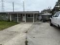 Exterior view of single-story house with a boat and truck parked in the long driveway at 442 Country Club Dr, Oldsmar, FL 34677