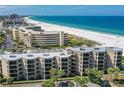 Aerial view of beachfront condo building with ocean and beach at 4510 Gulf Blvd # 408, St Pete Beach, FL 33706