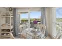 Ocean view dining area with glass table and wicker chairs at 4510 Gulf Blvd # 408, St Pete Beach, FL 33706