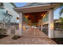 Covered entryway with a white metal gate leading to the waterfront at 477 20Th Ave, Indian Rocks Beach, FL 33785