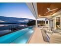 Stunning waterfront property featuring a luxurious infinity pool, spacious patio, and breathtaking water views at 477 20Th Ave, Indian Rocks Beach, FL 33785