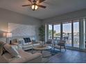 Bright living room with water views, comfortable seating, and hardwood floors at 530 S Gulfview Blvd # 205, Clearwater, FL 33767