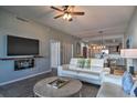 Living room features a large TV, fireplace, and comfortable seating at 530 S Gulfview Blvd # 205, Clearwater, FL 33767