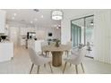 Bright dining area with four chairs and access to back patio at 5322 Windy Grove Dr, Wimauma, FL 33598