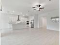 Modern kitchen with island and stainless steel appliances at 5322 Windy Grove Dr, Wimauma, FL 33598