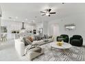 Open-concept living area with large sofa and view into kitchen at 5322 Windy Grove Dr, Wimauma, FL 33598