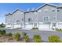 Gray townhouses, white garages, manicured landscaping at 5736 Biscayne Ct # 3, New Port Richey, FL 34652