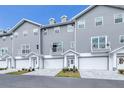 Three-story townhouses, gray siding, white garage doors at 5736 Biscayne Ct # 3, New Port Richey, FL 34652