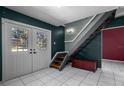 An entryway with a staircase and a dark-colored wall at 705 Whiteway Dr, Brooksville, FL 34601