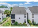 Two-story building exterior, featuring white siding and a walkway at 706 Haven Pl, Tarpon Springs, FL 34689