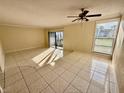 Bright living room with tile floors and sliding glass doors leading to a patio at 706 Haven Pl, Tarpon Springs, FL 34689