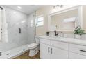 Updated bathroom with marble shower and modern vanity at 908 Victoria St, Brandon, FL 33510