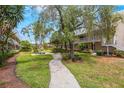 Community courtyard with lush landscaping, walkways, and seating area at 10033 64Th N Ave # 16, St Petersburg, FL 33708