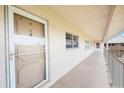 Building hallway with light-colored walls, tiled flooring and a condo door at 10033 64Th N Ave # 16, St Petersburg, FL 33708