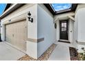 House exterior showcasing a two-car garage and walkway leading to the front door at 12940 Brookside Moss Dr, Riverview, FL 33579