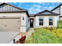 Beautiful one-story house featuring a two-car garage and nicely landscaped front yard at 12940 Brookside Moss Dr, Riverview, FL 33579