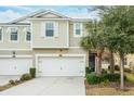 Two-story townhome with attached two-car garage and well-maintained landscaping at 1815 Sunset Wind Loop # 118, Oldsmar, FL 34677