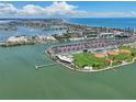 Aerial view showcasing waterfront community with a park, baseball field, and condo buildings at 343 Rex Pl # F, Madeira Beach, FL 33708