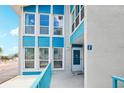 Condo building exterior showcasing a teal and white color scheme and balcony at 343 Rex Pl # F, Madeira Beach, FL 33708
