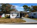 Mobile home exterior with carport and landscaped yard at 34421 Countryside Dr, Wesley Chapel, FL 33543