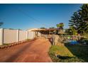 Long driveway leading to a ranch style home with a fenced backyard at 4506 24Th S Ave, Tampa, FL 33619