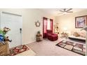 Living room with a red recliner, sofa bed, and cat tree at 534 19Th Nw St, Ruskin, FL 33570