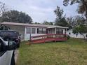House exterior with a ramp and yard at 5902 18Th St, Zephyrhills, FL 33542