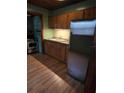 Galley kitchen with wood cabinets and appliances at 5902 18Th St, Zephyrhills, FL 33542