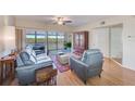 Bright living room with water views, leather furniture, and hardwood floors at 6315 Shoreline Dr # 3202, St Petersburg, FL 33708