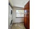 Laundry room with stacked washer and dryer, and built in cabinets at 9860 62Nd N Ter # 1013, St Petersburg, FL 33708