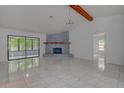 Bright living room with stone fireplace and sliding glass doors leading to patio at 10237 Carrin Rd, Spring Hill, FL 34608