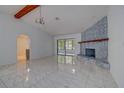 Open living room featuring a stone fireplace and access to other rooms at 10237 Carrin Rd, Spring Hill, FL 34608