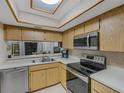 Kitchen with stainless steel appliances and wood cabinets at 11511 113Th St # 13H, Largo, FL 33778