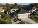 Single-story house with a two-car garage and landscaped yard at 1604 Boswell Ln, New Port Richey, FL 34655